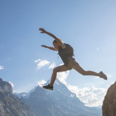 Woman jumping off cliff