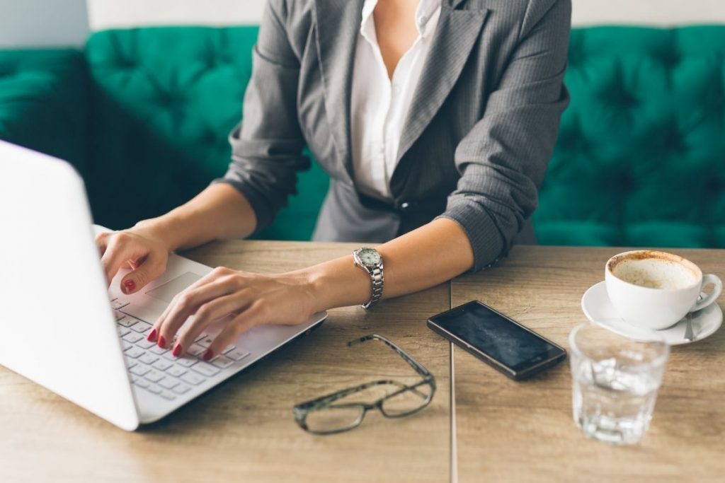 Woman on laptop learning how to make an extra $1000 a month