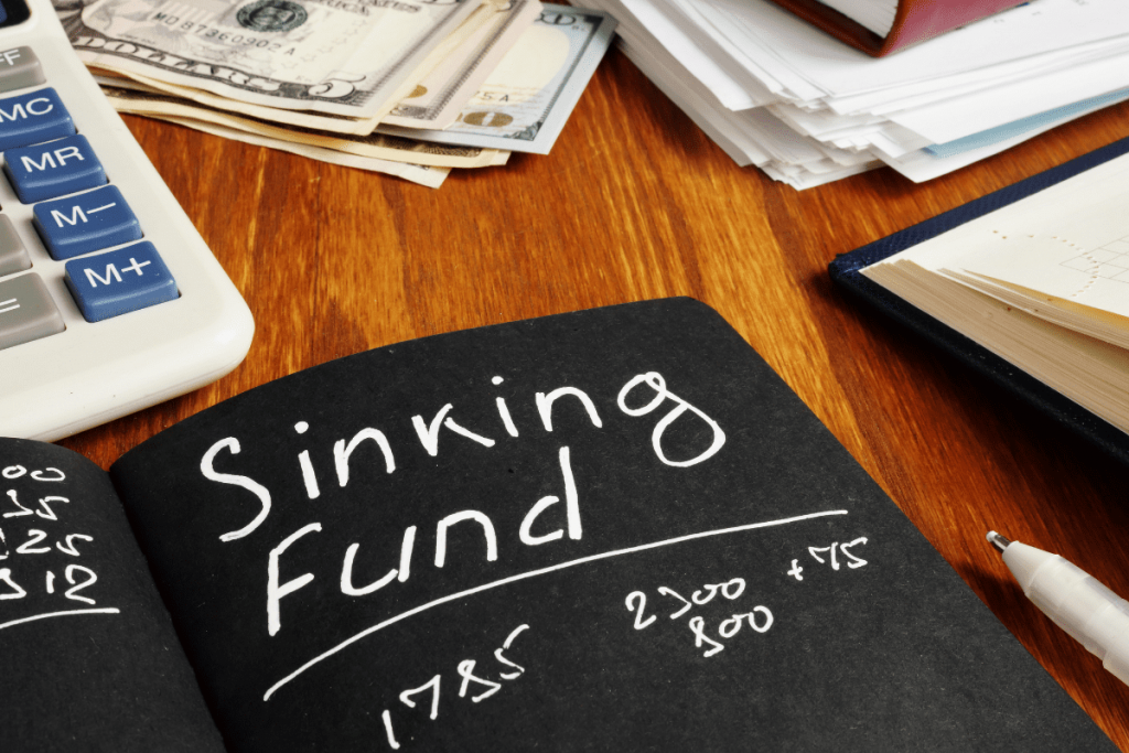 Sinking fund categories tracker with cash on desk